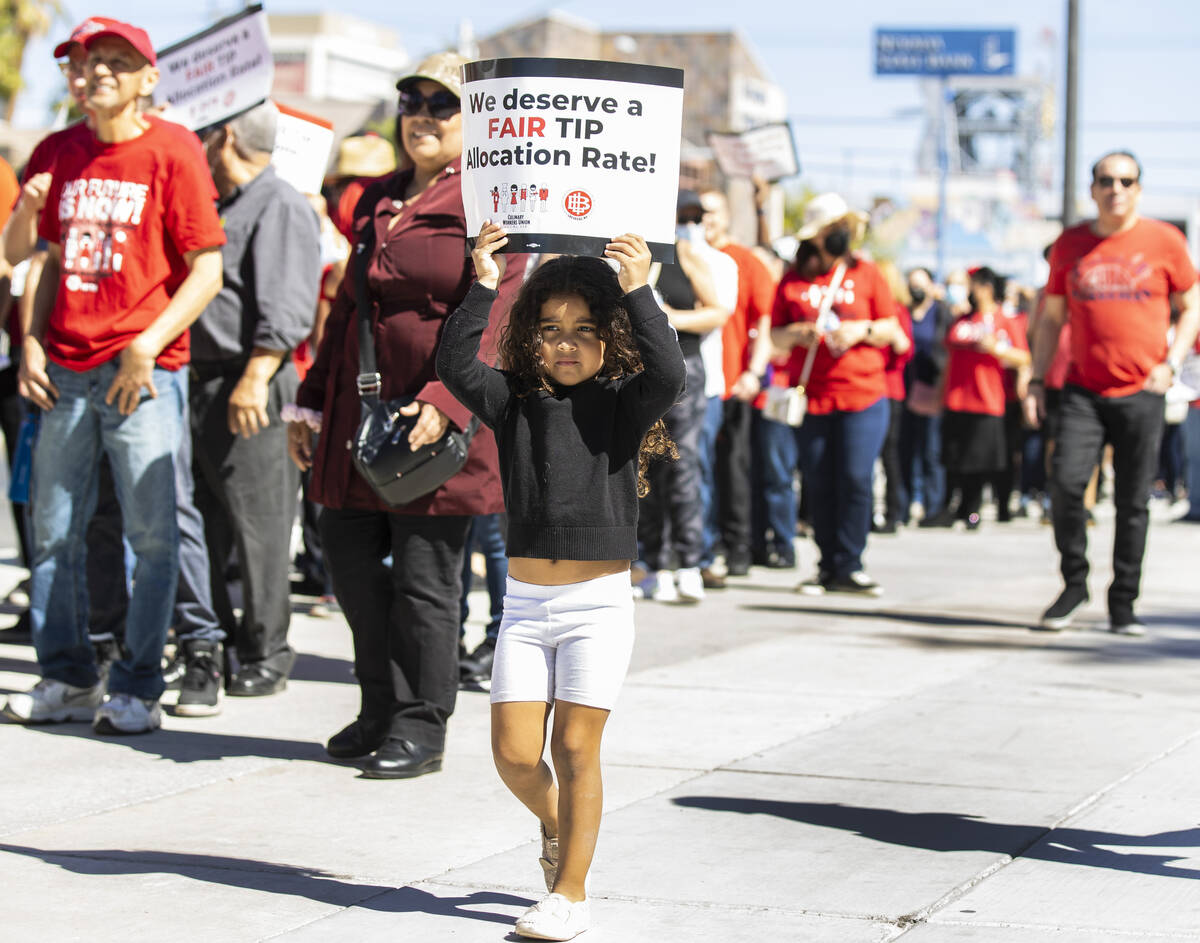 Adalia Luna, 5, holds a sign, Thursday, March 24, 2022, as hundreds of culinary and bartenders ...