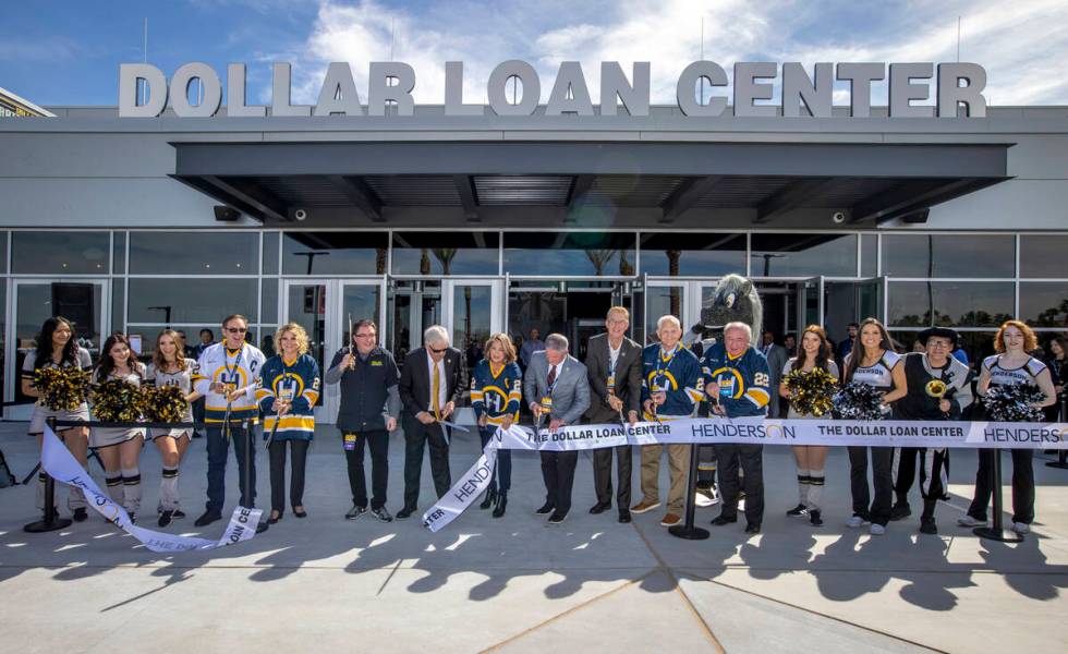 Dignitaries cut a ribbon beside arena staff during a ceremony for the new Dollar Loan Center on ...