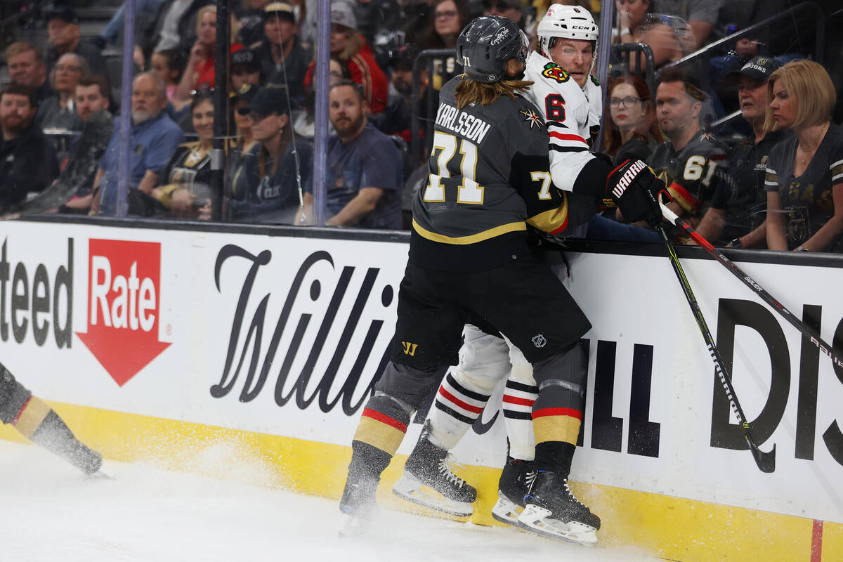 Vegas Golden Knights center William Karlsson (71) slams Chicago Blackhawks defenseman Jake McCa ...