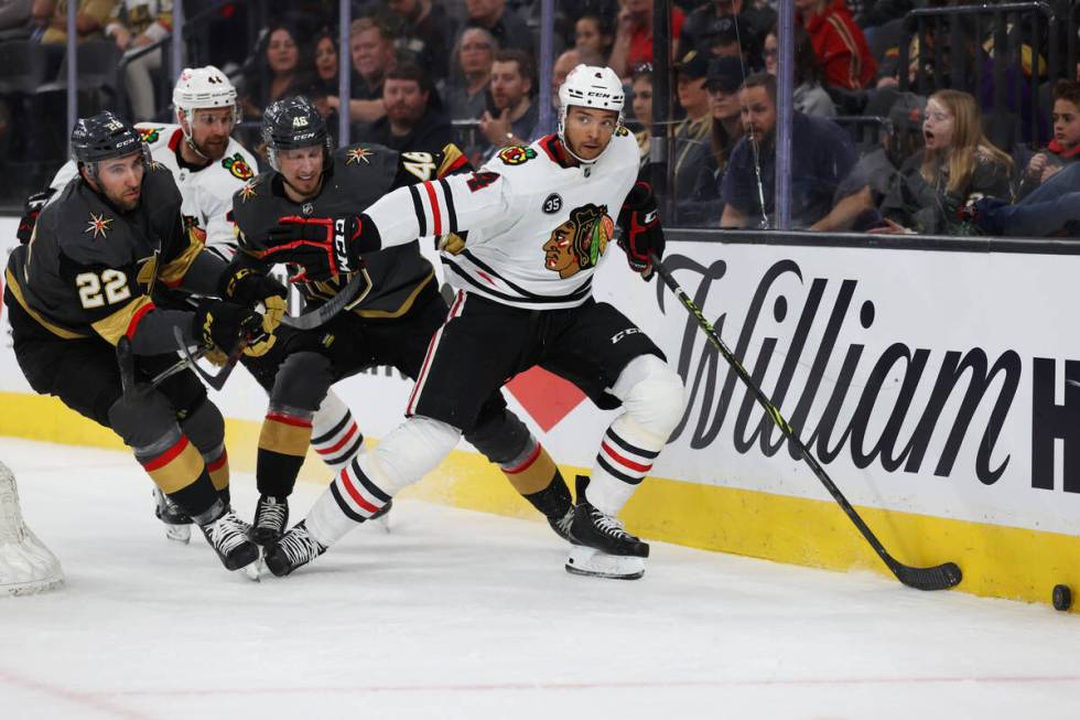 Vegas Golden Knights center Michael Amadio (22) and right wing Jonas Rondbjerg (46) pressure Ch ...