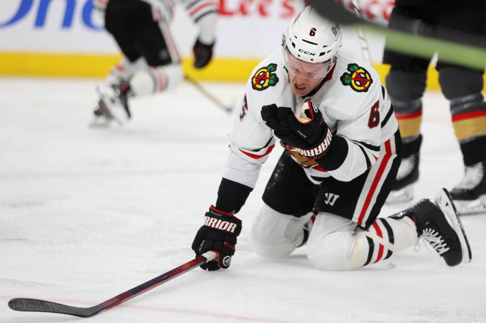 Chicago Blackhawks defenseman Jake McCabe (6) reacts after getting hit during the second period ...