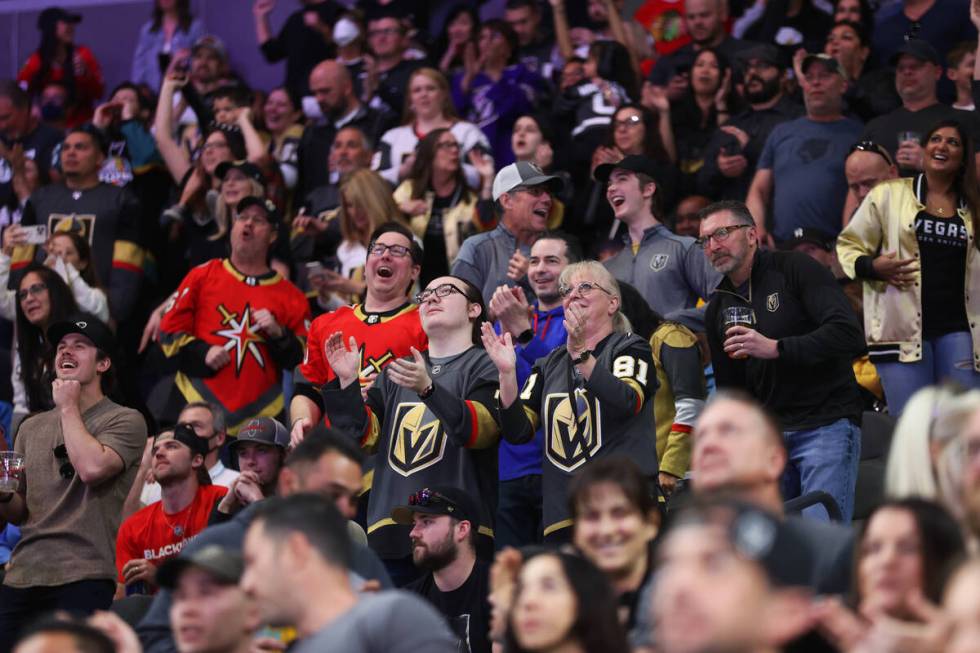 Fans celebrate after a Vegas Golden Knights goal during the third period of an NHL hockey game ...