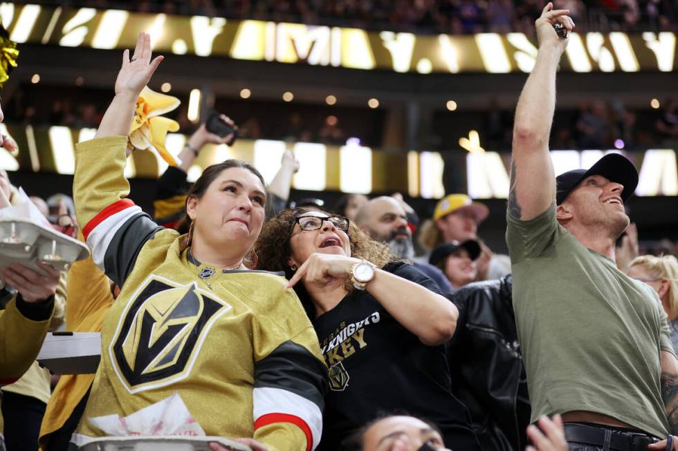 Fans celebrate after a Vegas Golden Knights goal during the third period of an NHL hockey game ...