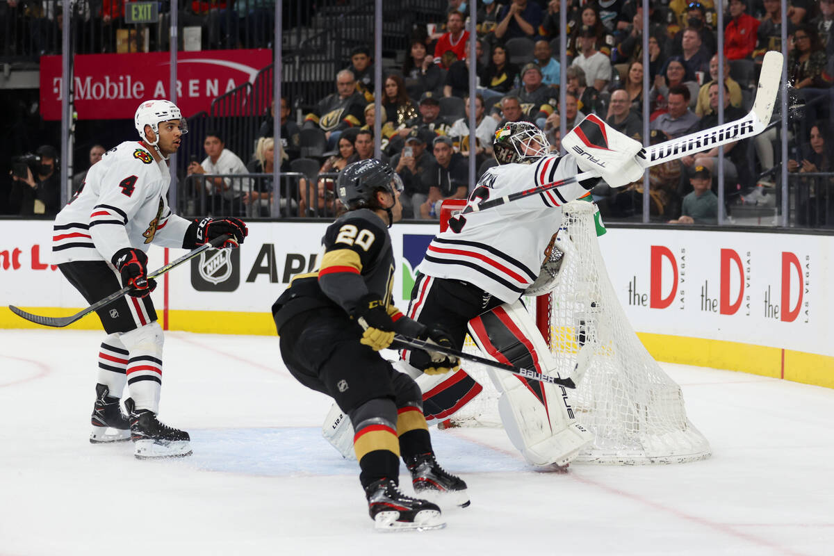 Chicago Blackhawks goaltender Kevin Lankinen (32) and defenseman Seth Jones (4) defend against ...