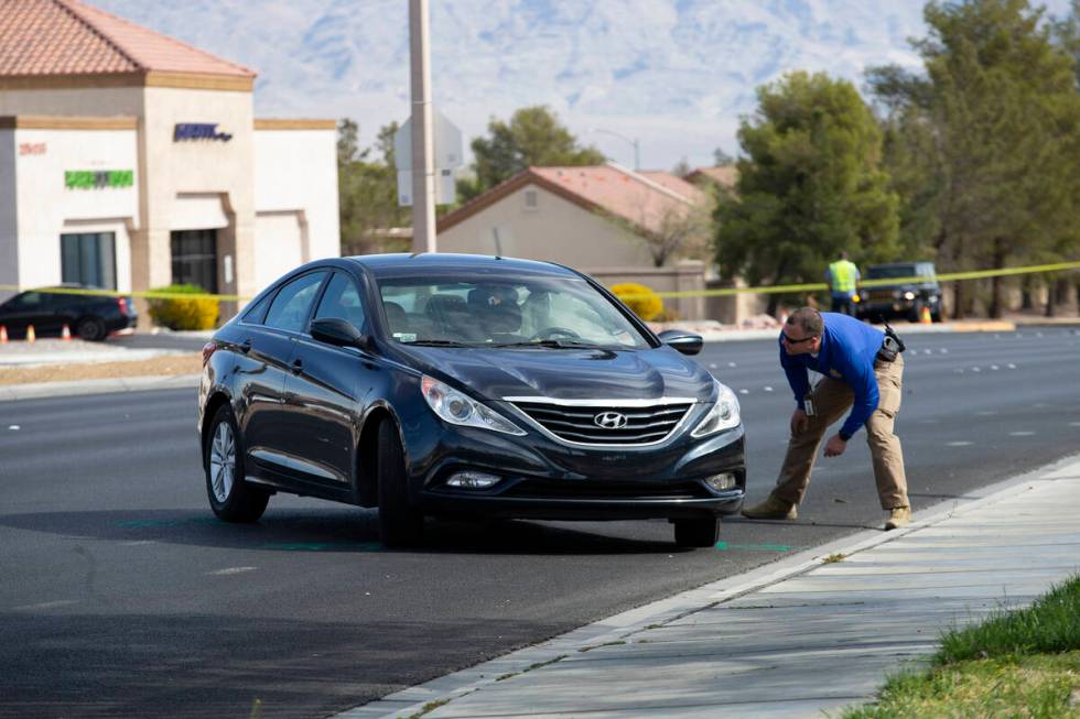 Las Vegas police attend to the scene where a motorcyclist died in a crash at the intersection o ...