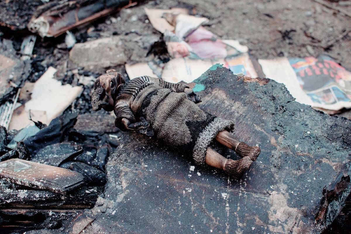 A view of a burned doll in a yard of a residential building damaged by shelling, in Chernihiv, ...