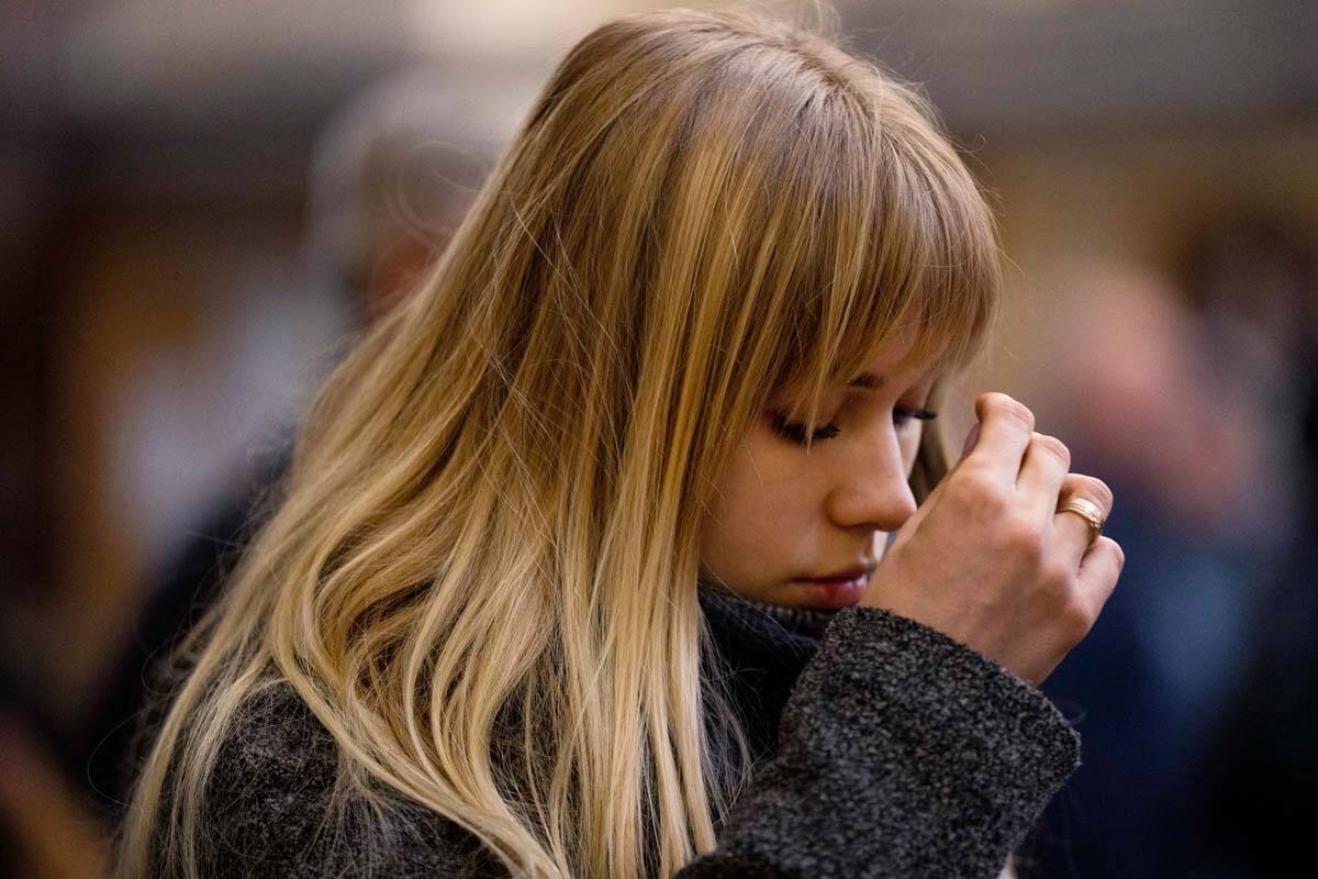 A woman prays during Mass at the Holy Eucharist Church, a day after Russian rockets hit an oil ...