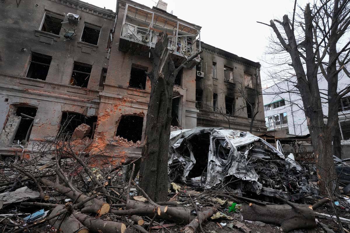 A damaged building and car after recent shelling, in the center of Kharkiv, Ukraine, Sunday, Ma ...