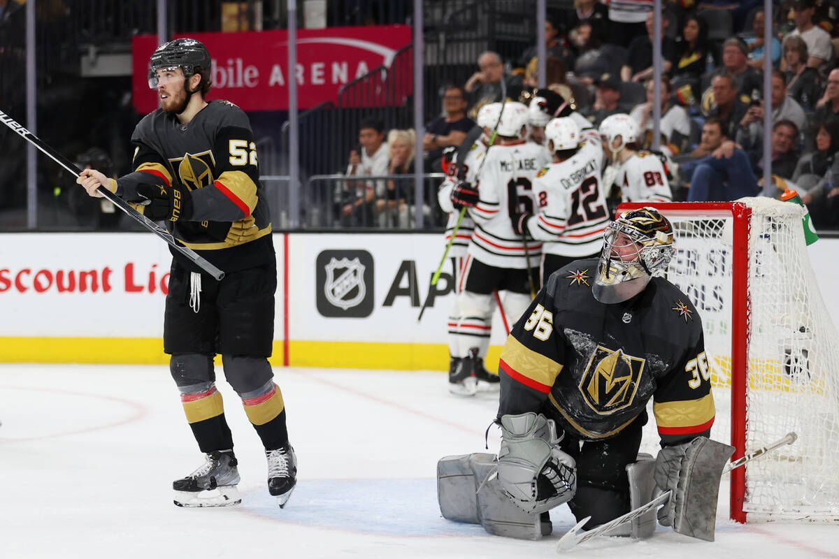 Vegas Golden Knights defenseman Dylan Coghlan (52) and goaltender Logan Thompson (36) look on a ...