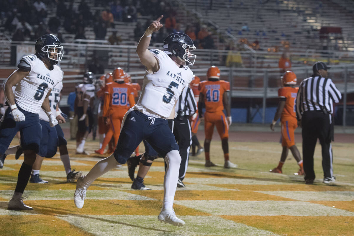 Marietta's Harrison Bailey (5) celebrates after a touchdown in Friday night's state semifinal g ...