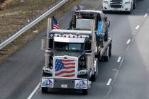 A convoy of trucks and other vehicles travels the I-495 Capital Beltway near the Woodrow Wilson ...