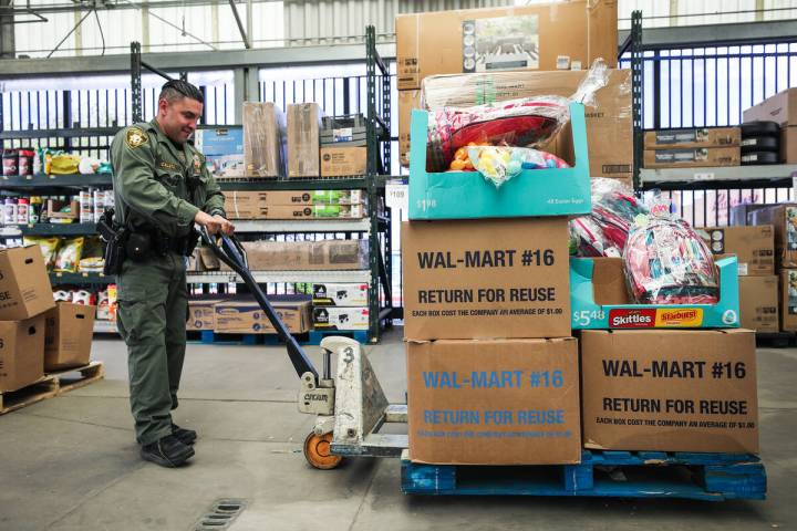 Metro officer Alfredo Calata moves a pallet of Easter baskets and gifts to be donated to childr ...