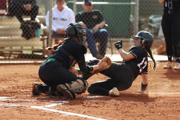 Faith Lutheran’s McKenna Young (13) beats a tag by Green Valley’s Angelina Ortega ...
