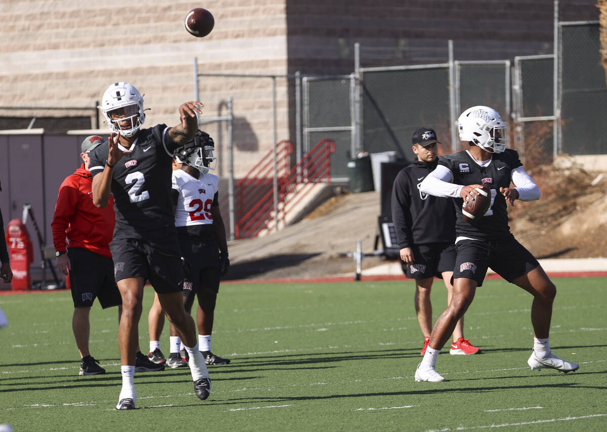 UNLV Rebels quarterbacks Doug Brumfield, left, and Cameron Friel work on drills during the firs ...