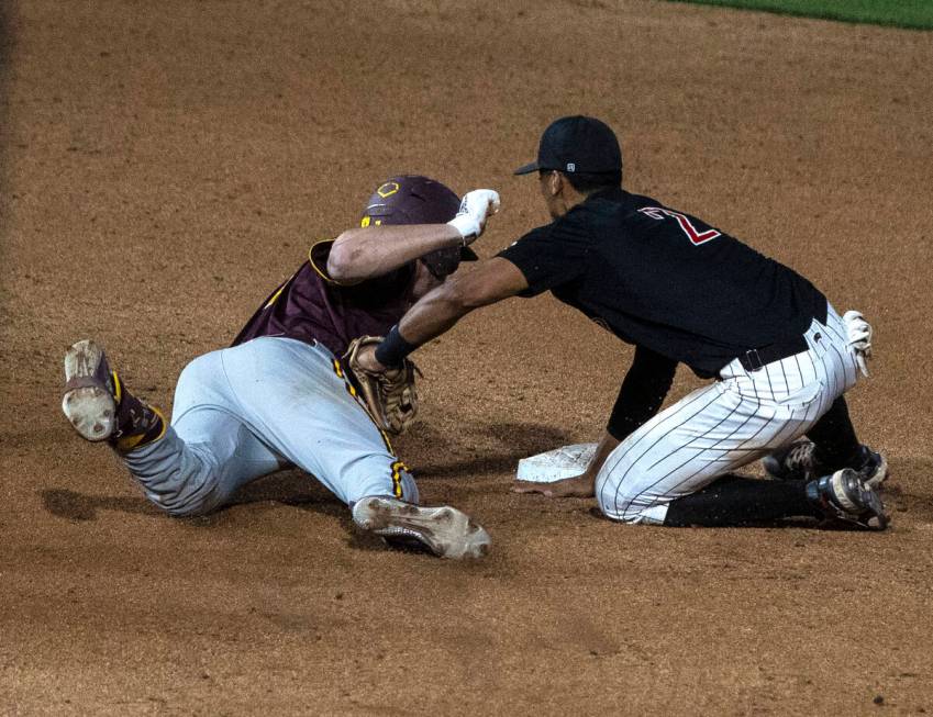 Arizona St. outfielder Conor Davis (7) is tagged out by UNLV infielder Edarian Williams (2) at ...
