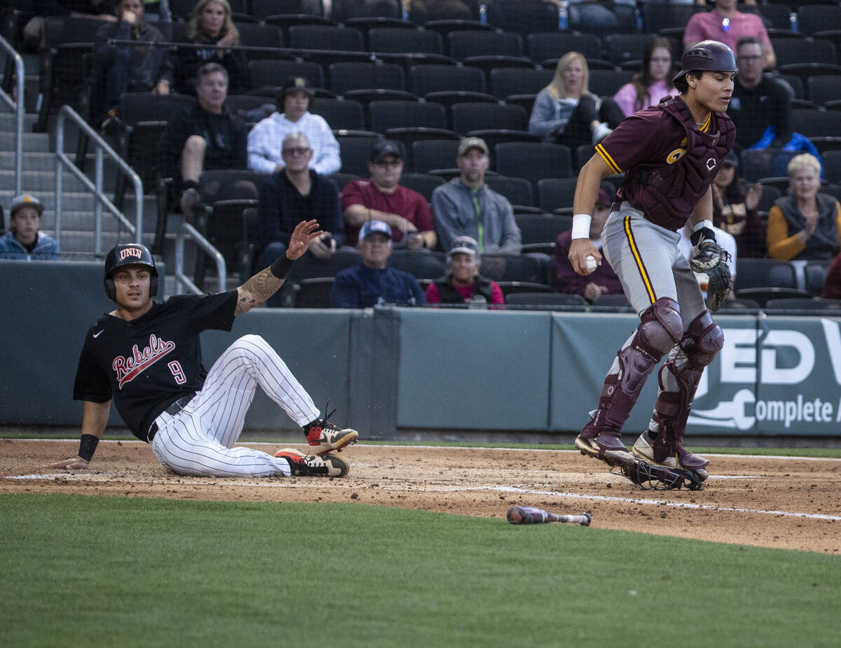 UNLV outfielder Joey Walls (9) protests the call after sliding into home plate during the secon ...
