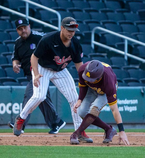 Arizona St. outfielder Joe Lampe (5) is tagged out by UNLV infielder Diego Alarcon (6) at third ...