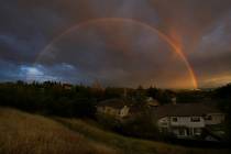 A rainbow appears at sunset as storm clouds approach in Martinez, Calif., on Monday, March 28, ...