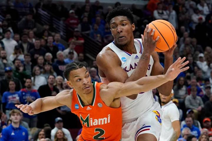 Kansas' David McCormack tries to get past Miami's Isaiah Wong during the second half of a colle ...