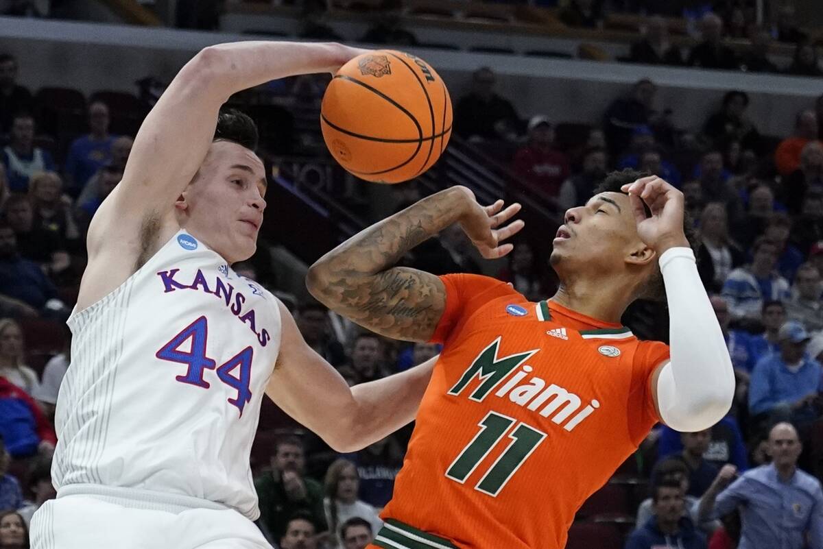 Kansas' Mitch Lightfoot and Miami's Jordan Miller go for a rebound during the second half of a ...