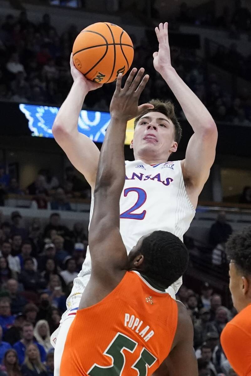 Kansas' Christian Braun shoots over Miami's Wooga Poplar during the first half of a college bas ...