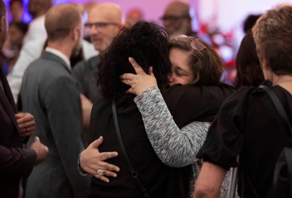 Alicia Jimenez, life partner of Elwood Hensey, is consoled by friends and family during a funer ...