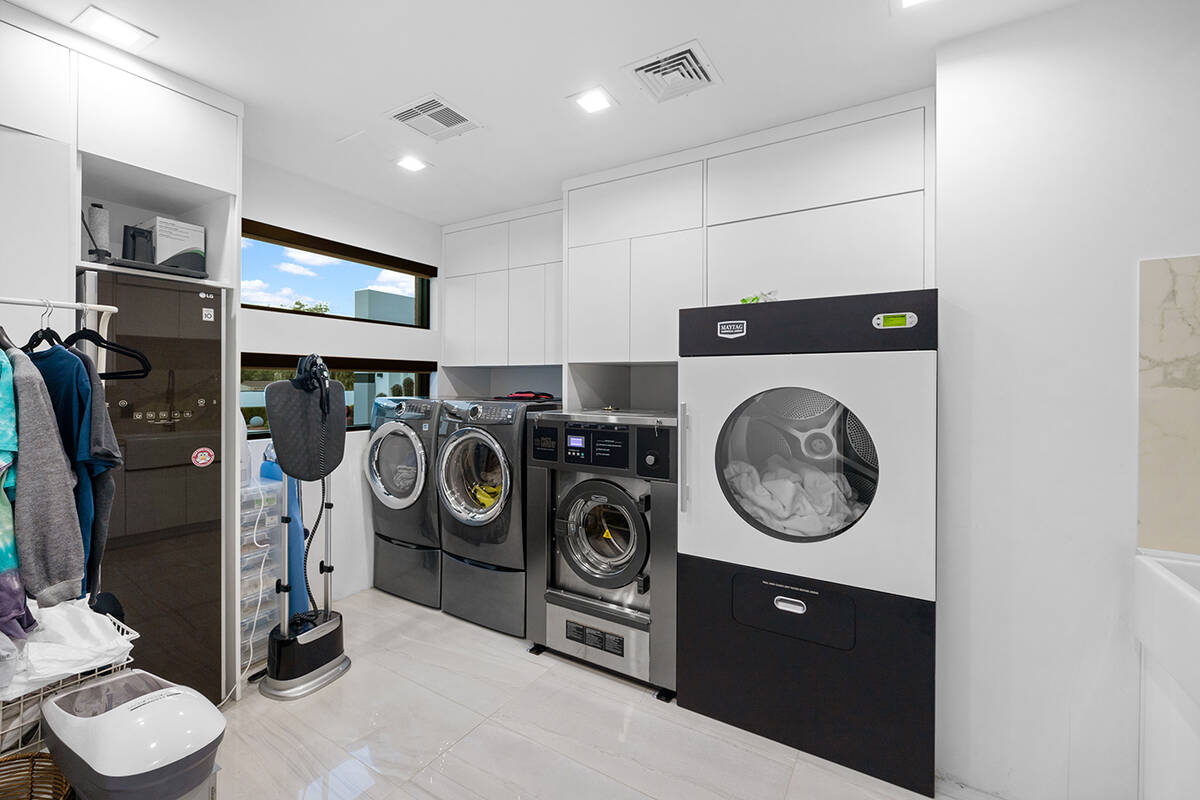 The laundry room features commercial washer and dryer and dry cleaner. (Napoli Group)