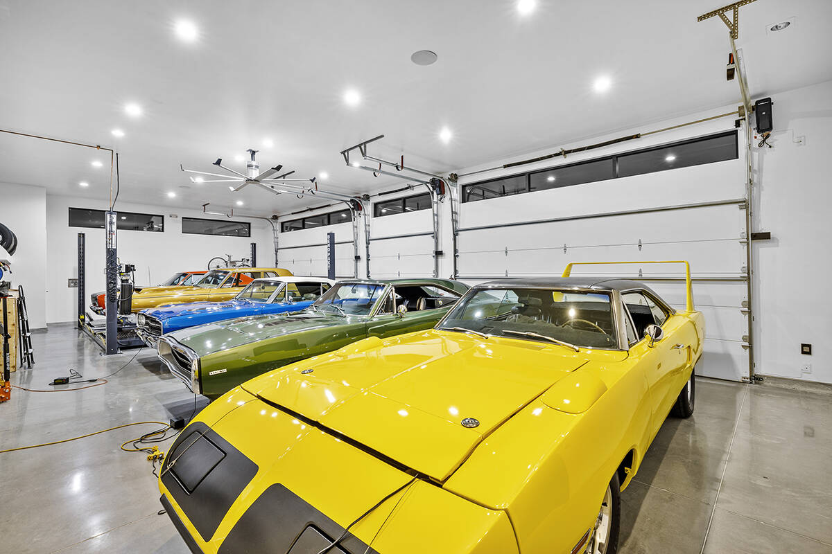 The two garages can accommodate 14 vehicles. One has a heavy-duty four-post dual platform car l ...