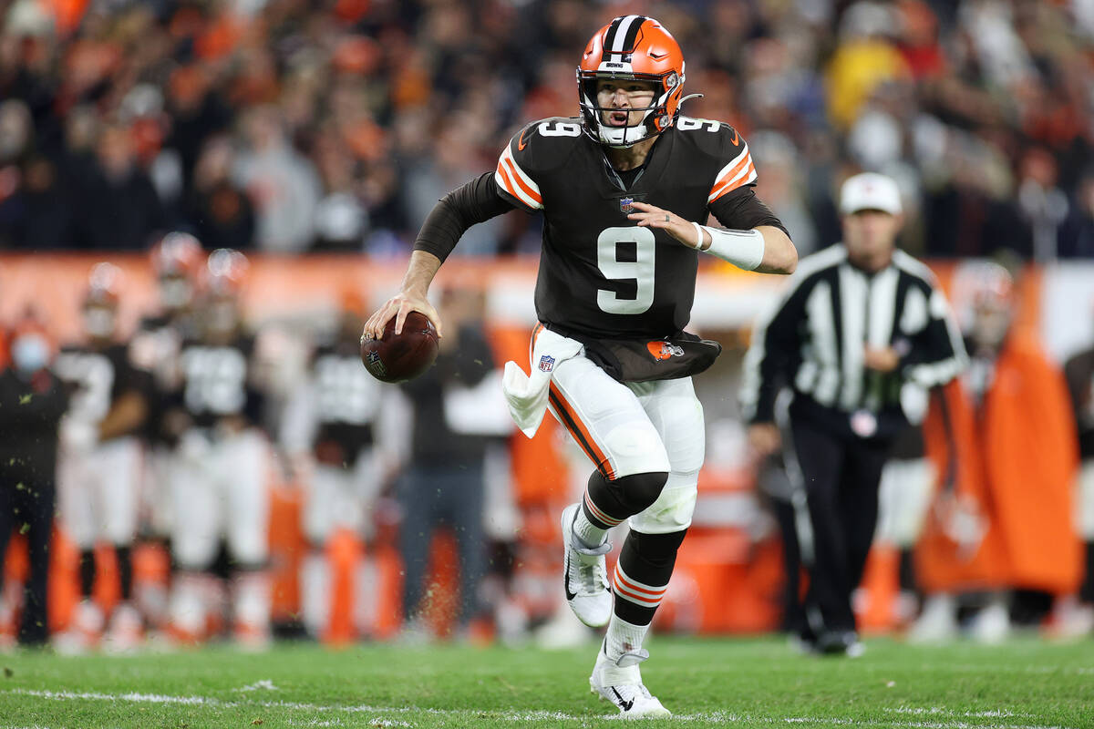 Cleveland Browns quarterback Nick Mullens (9) makes a run before throwing the ball for a touchd ...