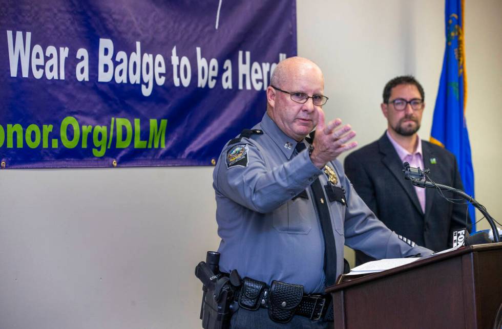 Nevada Highway Patrol Capt. Kevin Honea, left, speaks beside Clark County Commissioner Michael ...