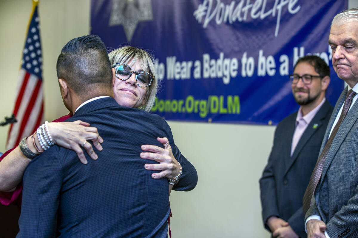 Nevada Donor Network Foundation President Steven Peralta, left, hugs Courtney Kaplan after she ...