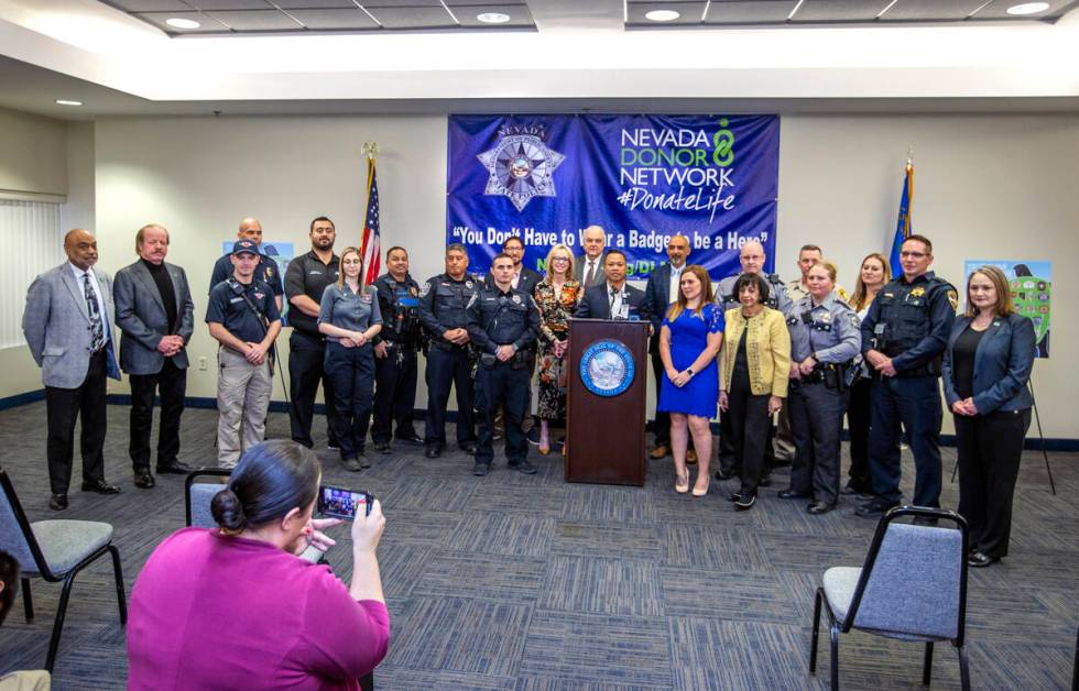 Gov. Steve Sisolak is joined by Clark County Commissioner Michael Naft and others following a p ...