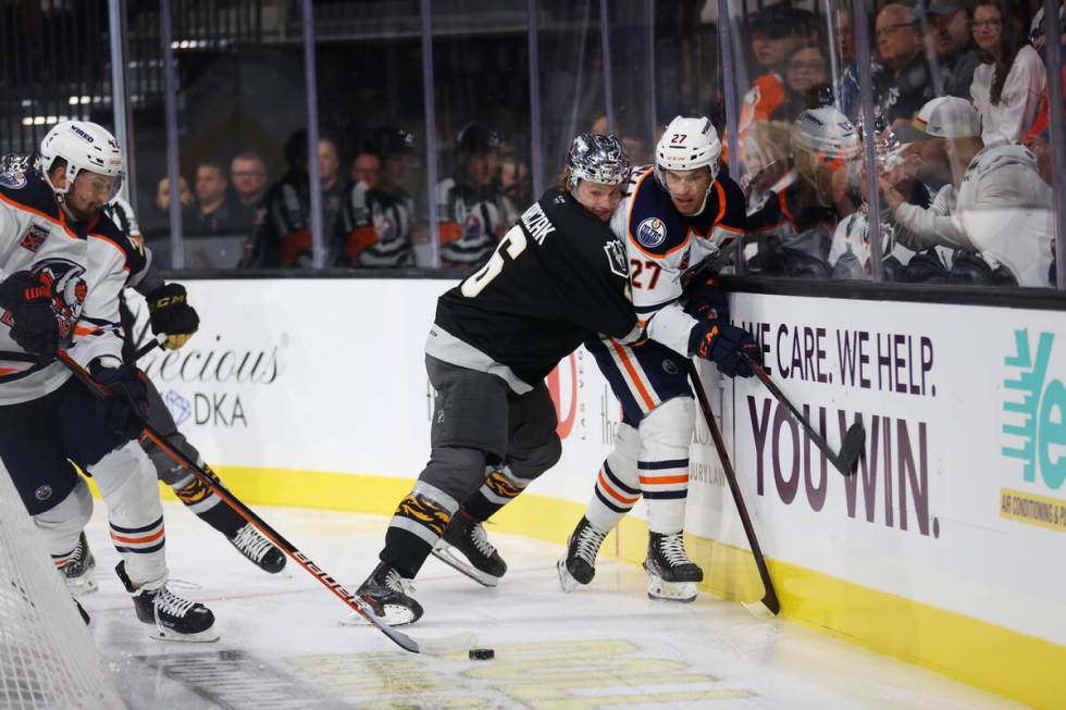 Henderson Silver Knights Kaedan Korczak (6) defends against Bakersfield Condors Adam Cracknell ...