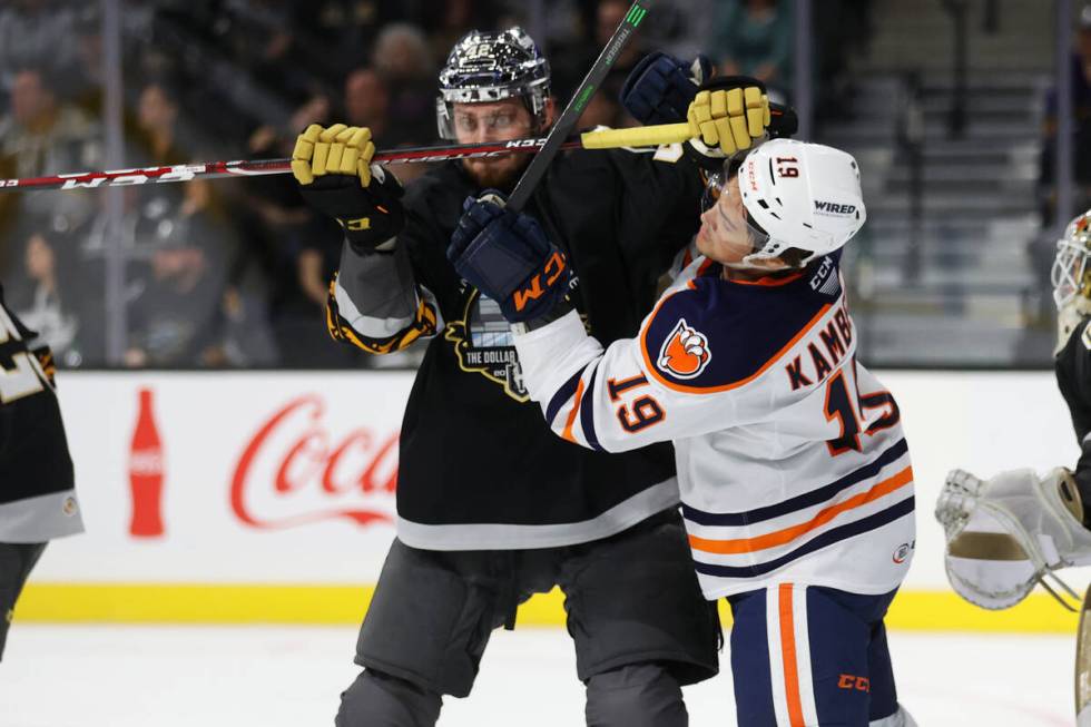 Henderson Silver Knights Daniil Miromanov (42) and Bakersfield Condors Dino Kambeitz (19) gets ...