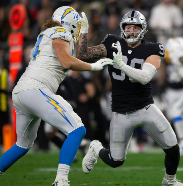 Raiders defensive end Maxx Crosby (98) works to get past Los Angeles Chargers offensive tackle ...