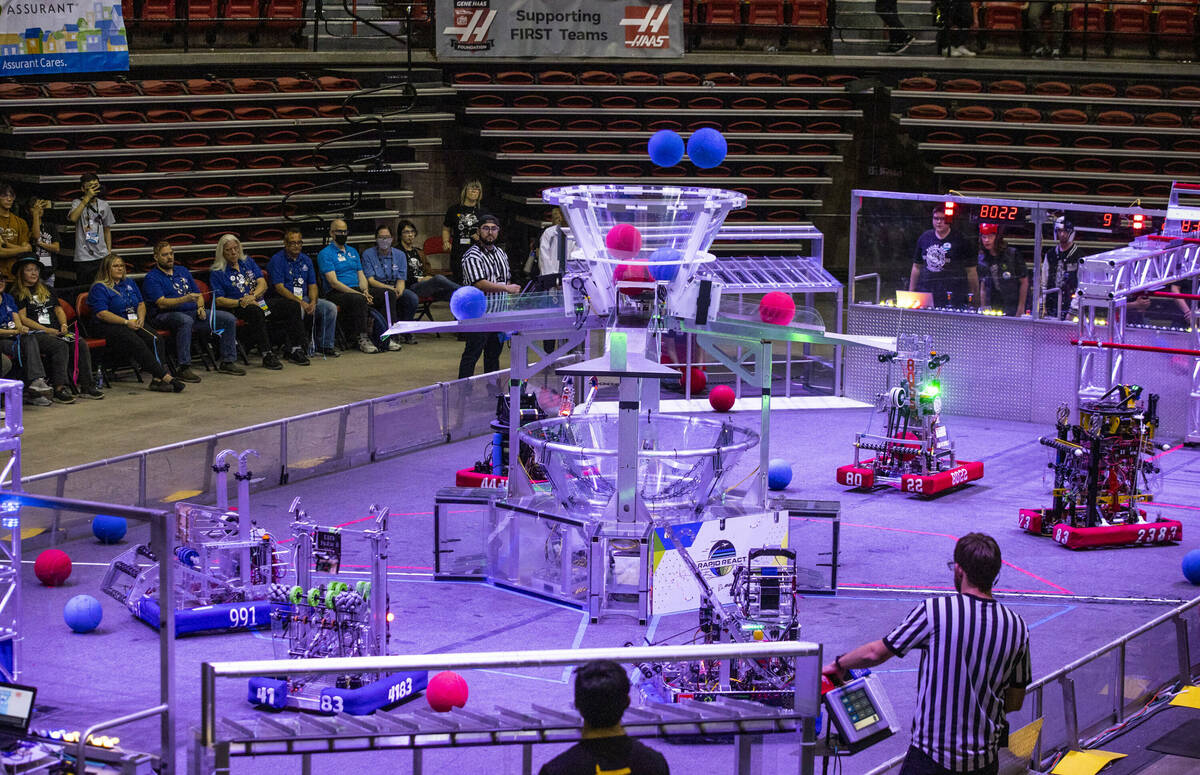 Robots compete in the arena during the FIRST Robotics Competition at the Thomas & Mack Cent ...