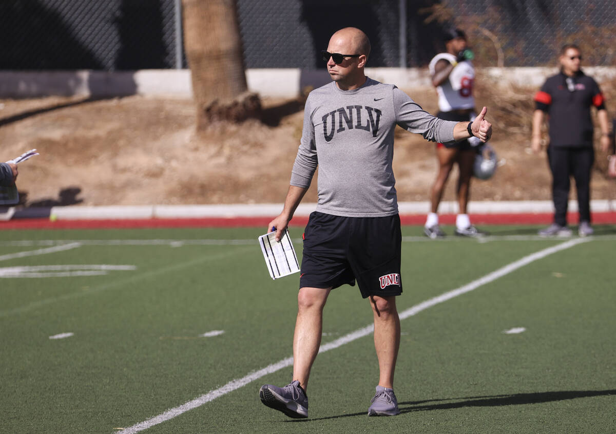 UNLV Rebels offensive coordinator Nick Holz motions to players during the first day of spring f ...
