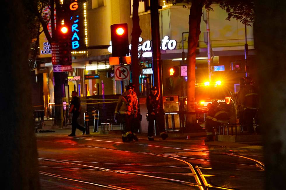 Emergency workers walk in downtown Sacramento, Calif., after an apparent mass shooting Sunday, ...