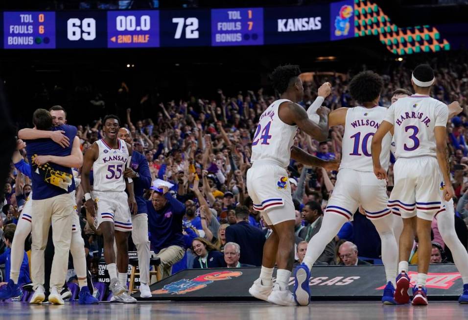 Kansas players celebrate after a college basketball game against North Carolina in the finals o ...