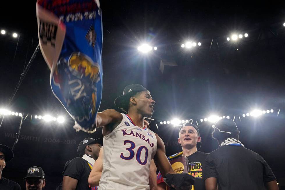 Kansas guard Ochai Agbaji celebrates after their win against North Carolina in a college basket ...