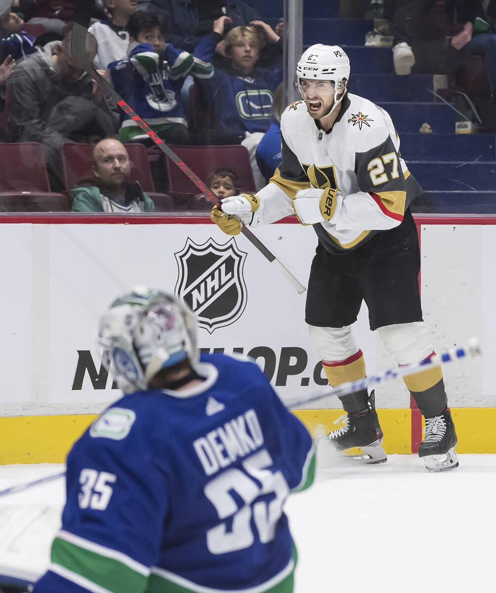 Vegas Golden Knights' Shea Theodore (27) celebrates after scoring against Vancouver Canucks goa ...