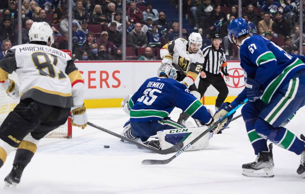 Vegas Golden Knights' Shea Theodore (27) scores against Vancouver Canucks goalie Thatcher Demko ...