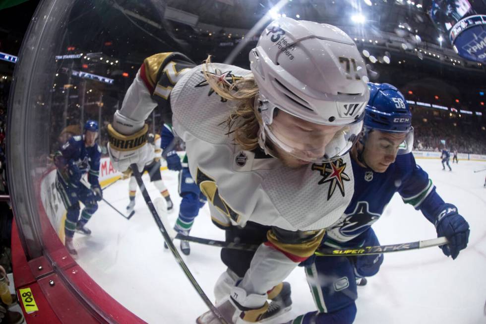 Vegas Golden Knights' William Karlsson (71), of Sweden, and Vancouver Canucks' William Lockwood ...