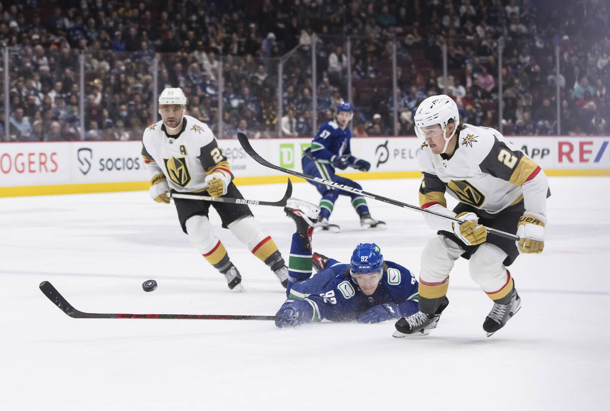 Vancouver Canucks' Vasily Podkolzin (92), of Russia, dives to knock the puck away from Vegas Go ...
