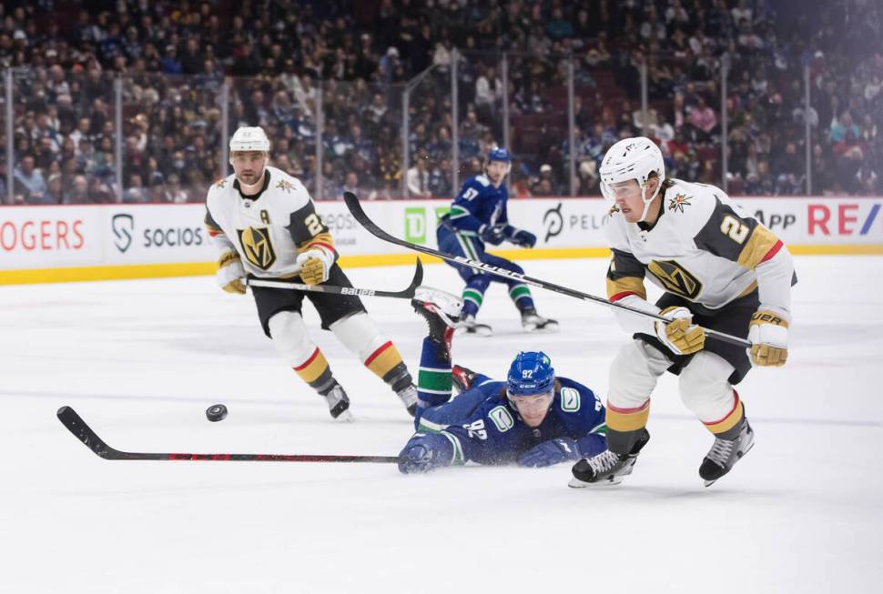 Vancouver Canucks' Vasily Podkolzin (92), of Russia, dives to knock the puck away from Vegas Go ...