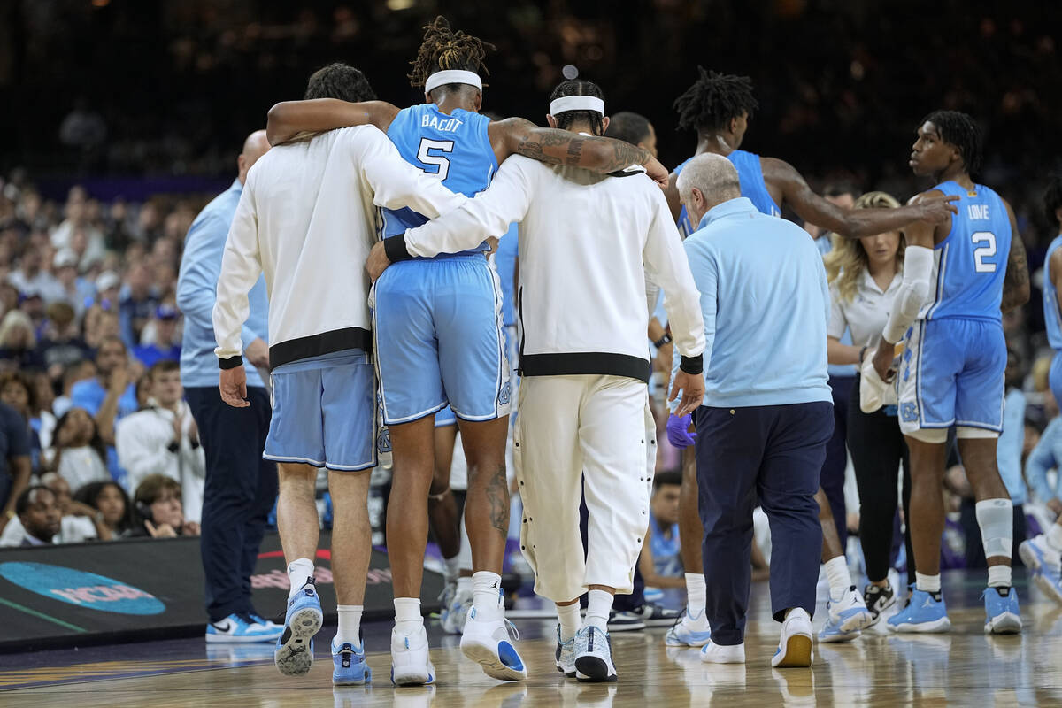 North Carolina forward Armando Bacot (5) is helped off the court during the second half of a co ...