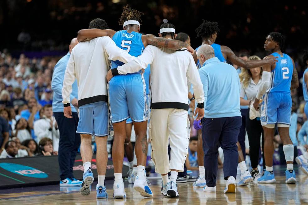 North Carolina forward Armando Bacot (5) is helped off the court during the second half of a co ...