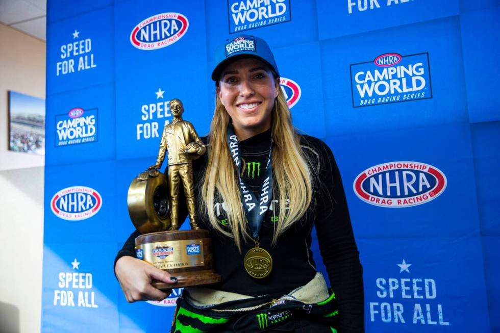 Top Fuel driver Brittany Force poses with her trophy after winning in Top Fuel at the NHRA Four ...