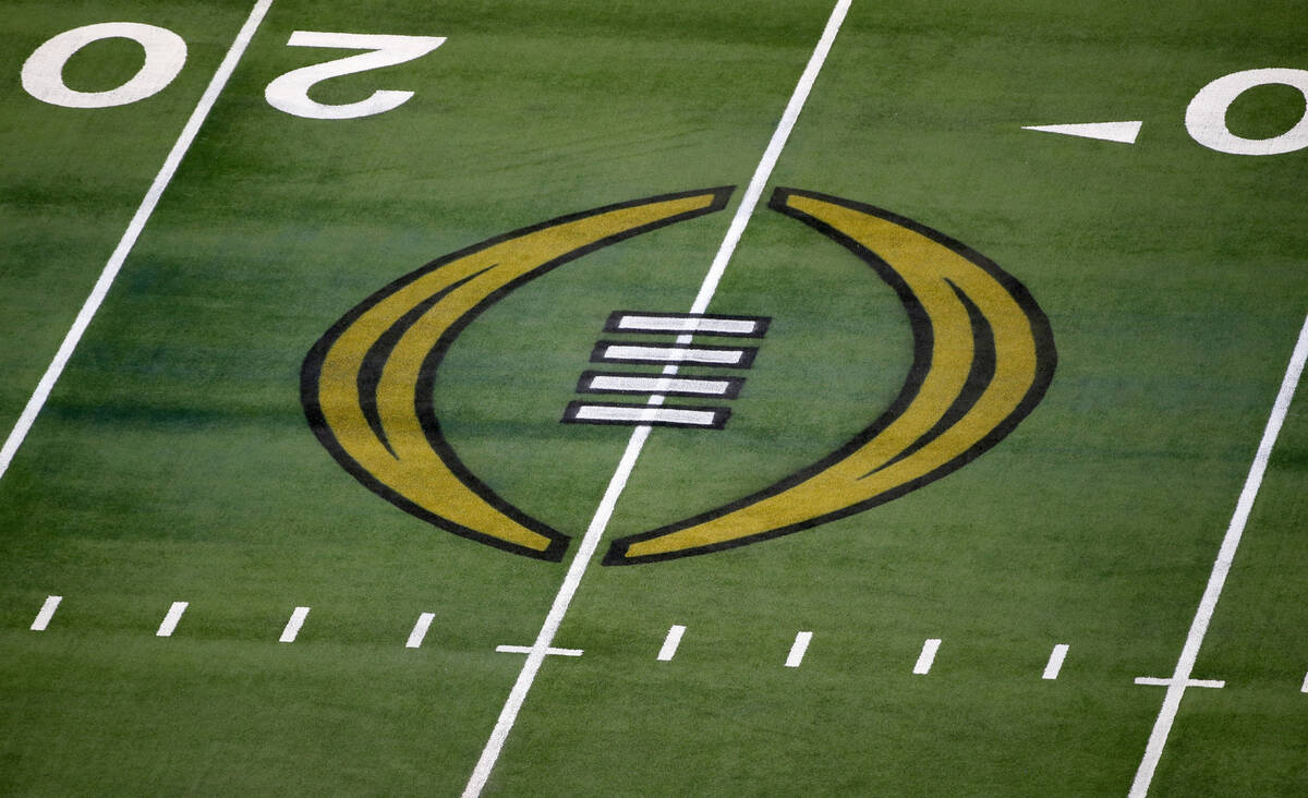 FILE - The College Football Playoff logo is shown on the field at AT&T Stadium before an NC ...