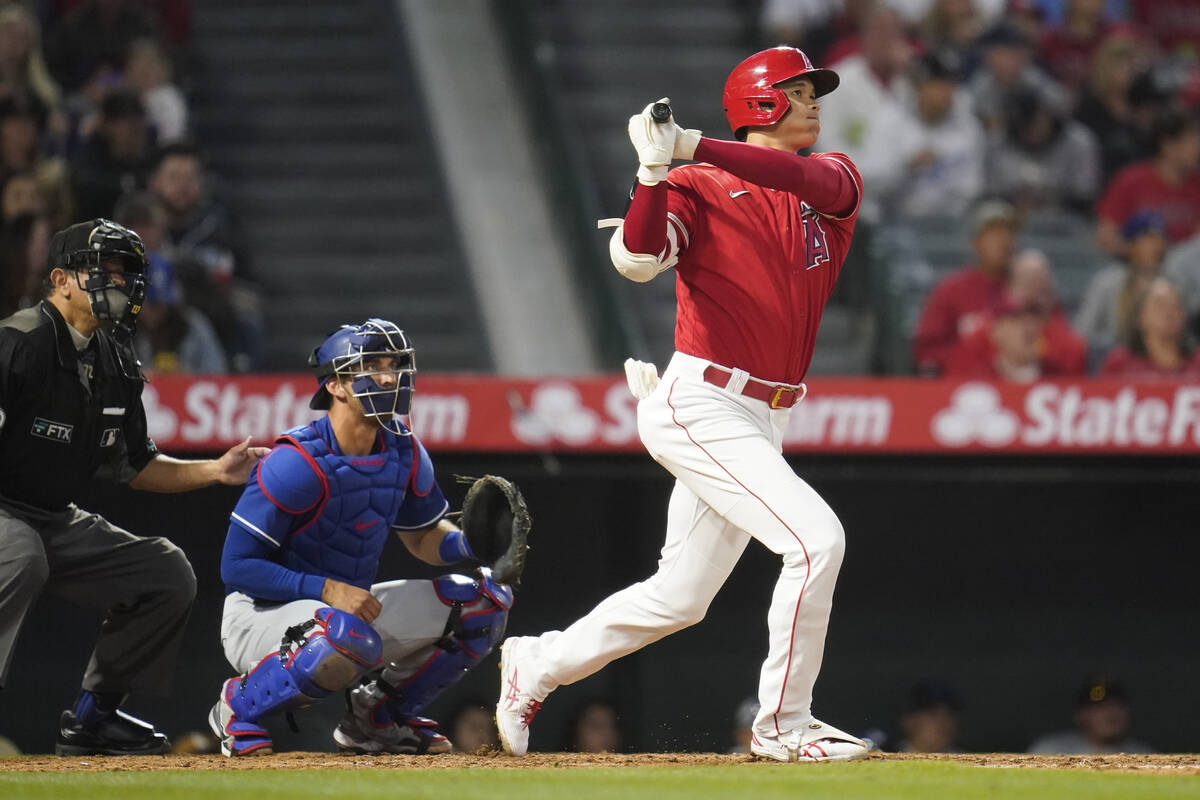Los Angeles Angels' Shohei Ohtani (17) watches as his ball flies over the fence for a home run ...